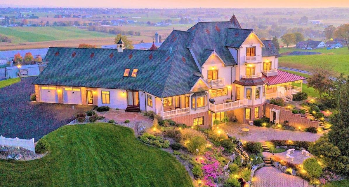 The Stories Made New mansion at dusk, aerial view